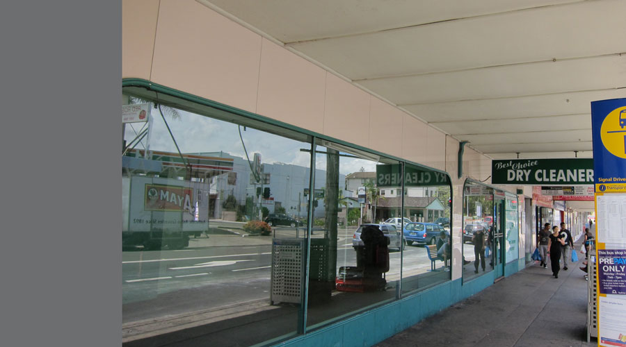 Before: the vacant shopfront's street-facing glazing under the awning, prior to the Snack King fitout